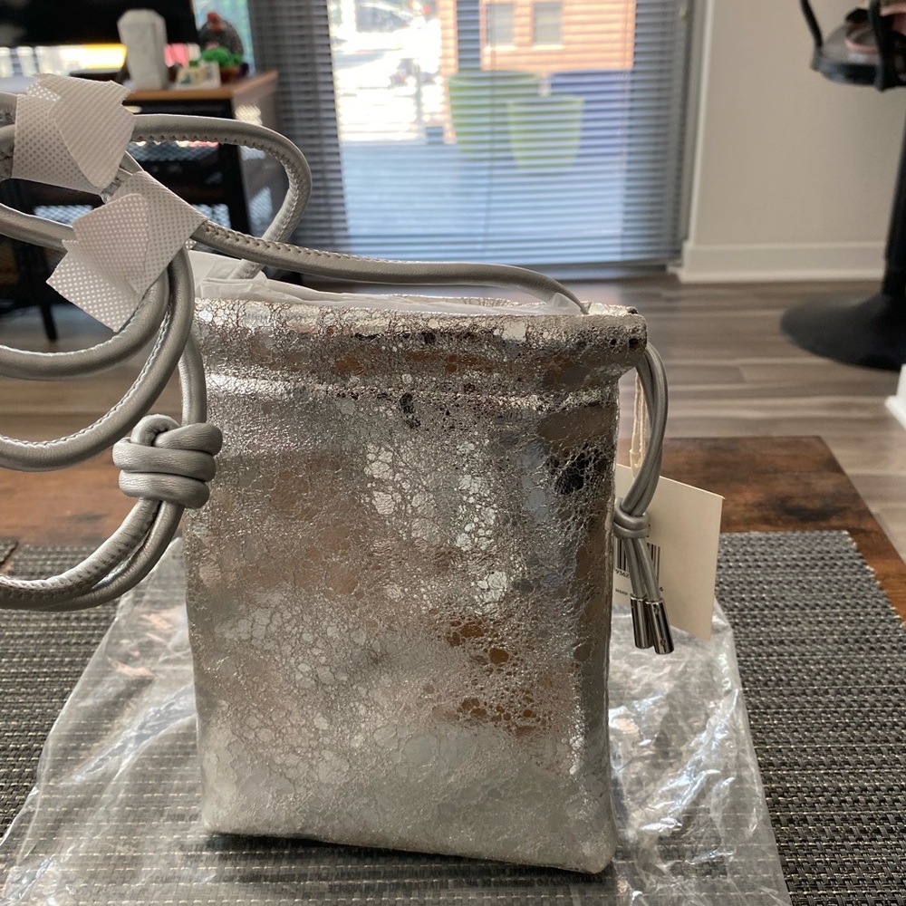 Dolce Vita Evie-B drawstring crossbody, leather silver metallic leather, NWT.
